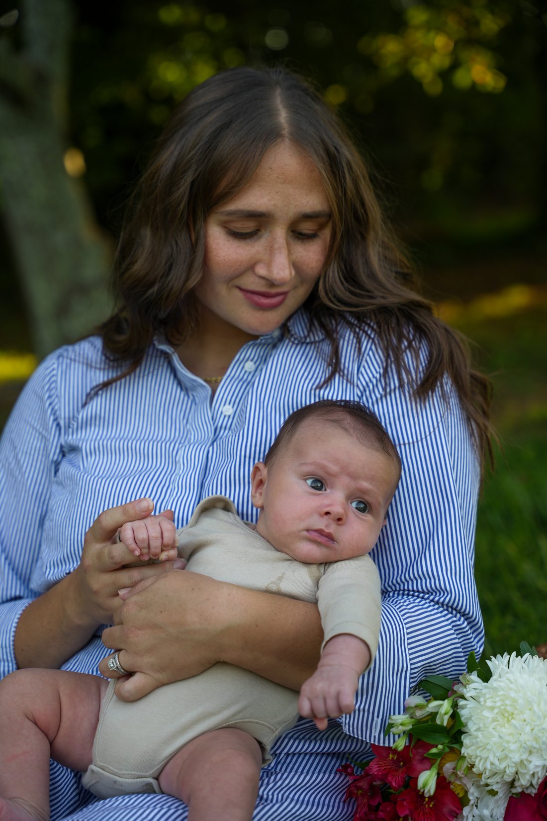 Mother holding her baby outdoors in golden light