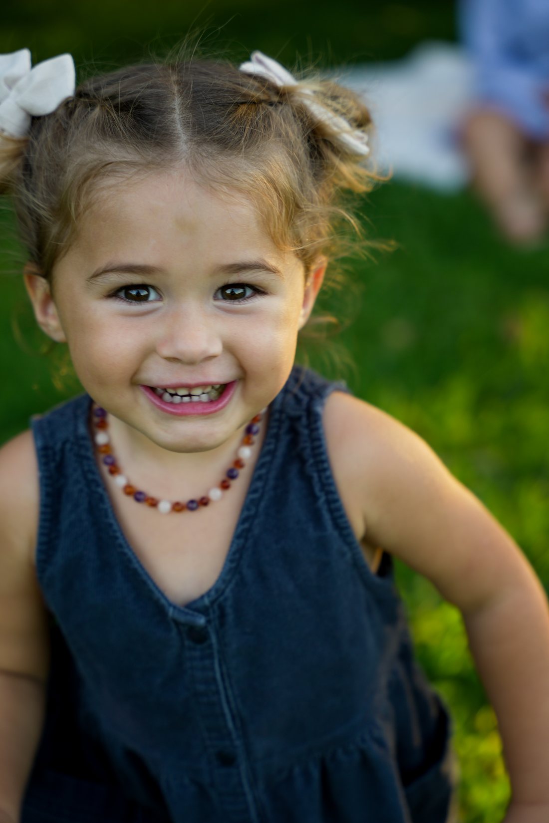 Smiling toddler with hair bows, close up